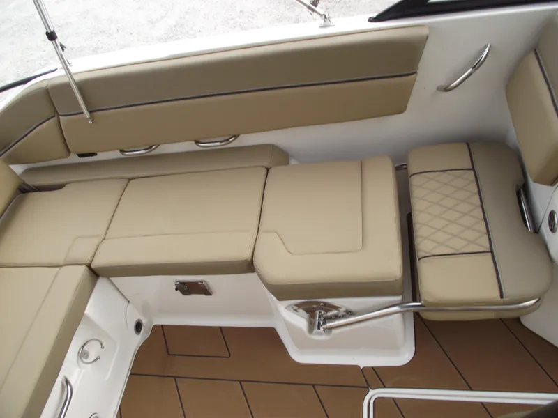 Slide: The Image of Interior seating of 2025 Bayliner D22 boat with beige cushions and sleek design. - 20