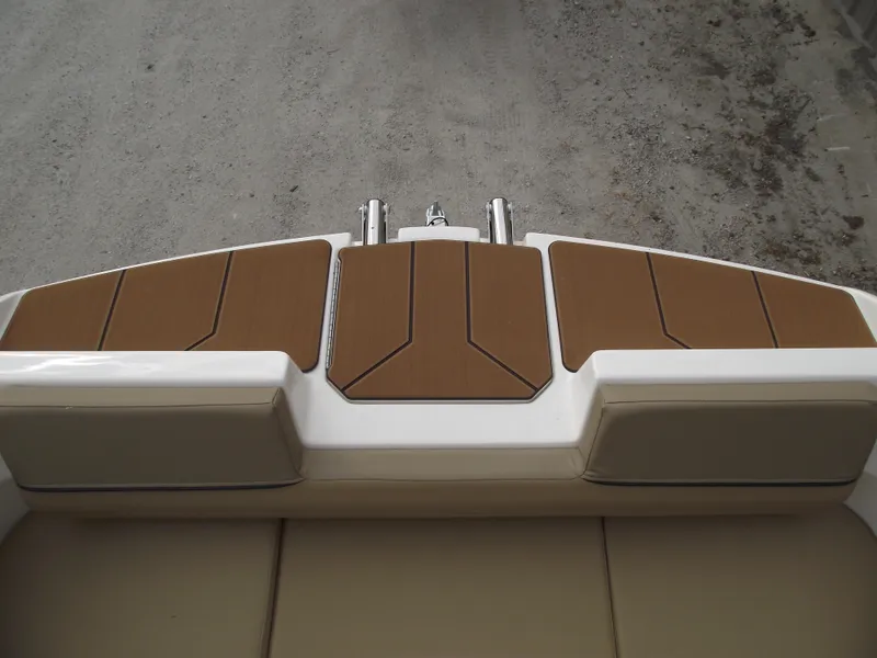 Slide: The Image of Bayliner D22 2025 boat deck with brown cushioned seating and sleek design. - 4