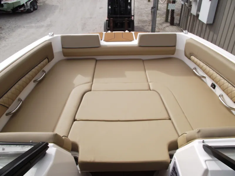 Slide: The Image of 2025 Bayliner D22 boat interior with beige cushioned seating. - 6