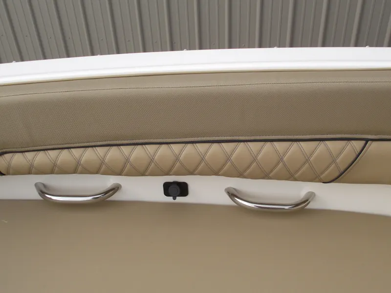 Slide: The Image of 2025 Bayliner D22 interior with beige quilted upholstery and stainless steel handles. - 9