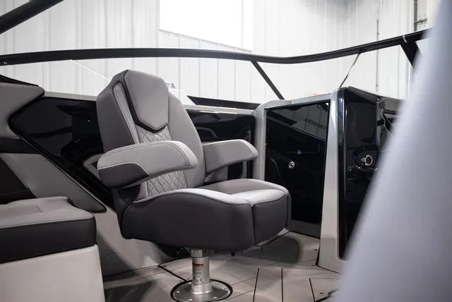 Slide: The Image of 2024 Yamaha Boats 255XE interior with sleek captain's chair and modern dashboard. - 10