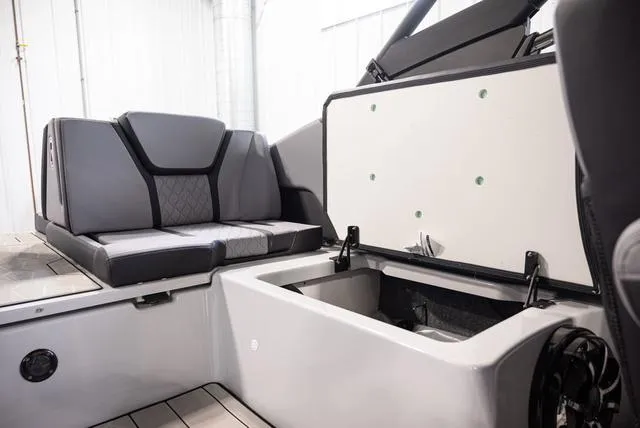 Slide: The Image of 2024 Yamaha Boats 255XE interior with seating and storage compartment. - 12