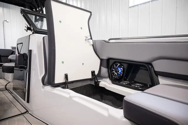 Slide: The Image of 2024 Yamaha Boats 255XE interior with open storage and speaker system. - 17