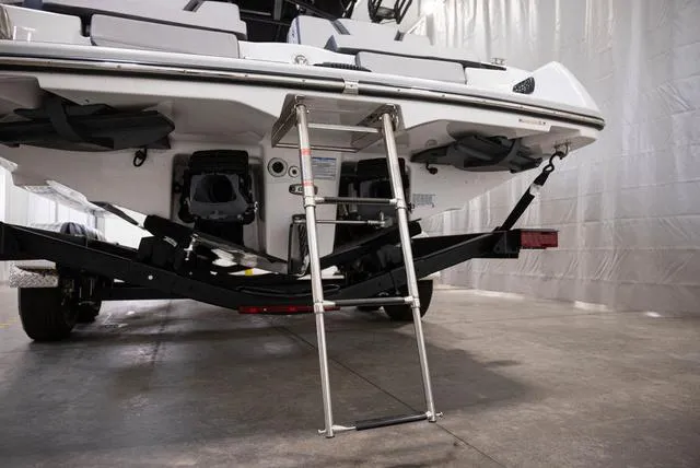 Slide: The Image of 2024 Yamaha Boats 255XE rear view with ladder in a garage setting. - 23