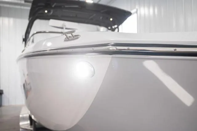 Slide: The Image of 2024 Yamaha Boats 255XE, sleek white hull, indoor showroom display. - 24