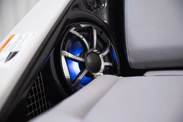 Slide: The Image of 2024 Yamaha Boats 255XE speaker with blue LED lighting, sleek interior design. - 28
