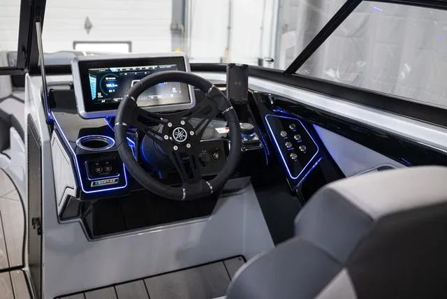 Slide: The Image of 2024 Yamaha Boats 255XE cockpit with modern dashboard and steering wheel. - 6