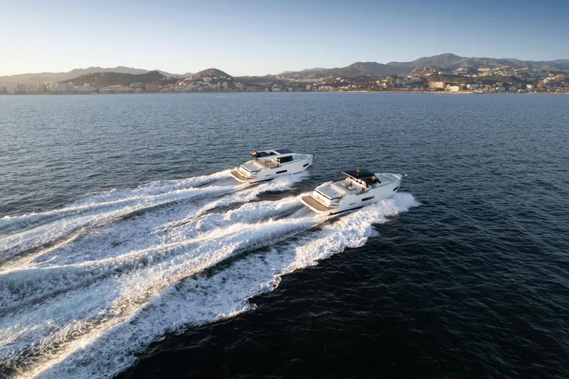 Slide: The Image of Two De Antonio Yachts D50 Coupé boats cruising on open water, 2025 model. - 13