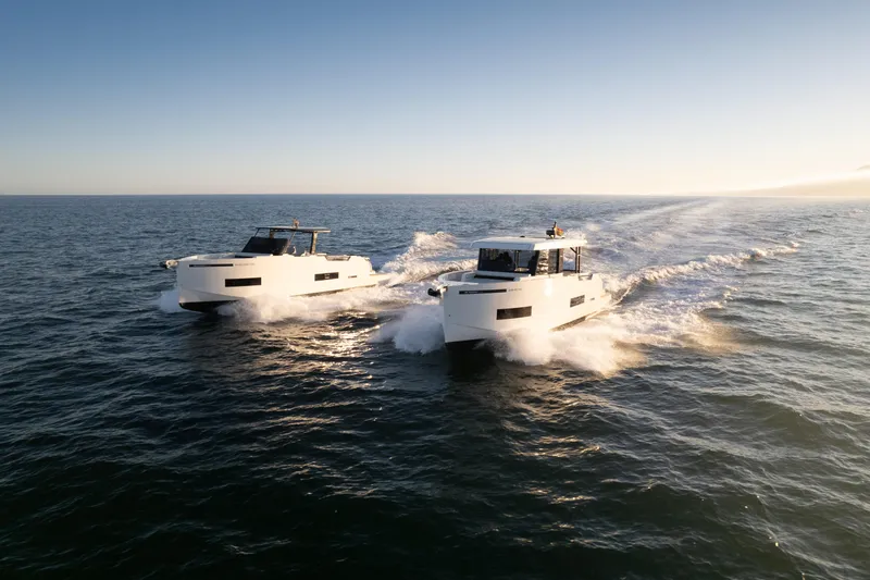 Slide: The Image of Two 2025 De Antonio Yachts D50 Coupé cruising on open water. - 14