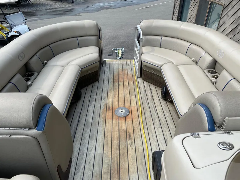 Slide: The Image of 2015 South Bay 724 E pontoon boat with beige seating and wooden deck. - 3
