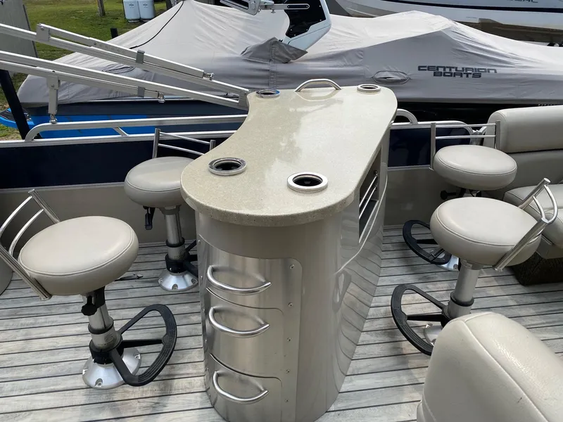 Slide: The Image of 2015 South Bay 724 E pontoon boat with bar seating and storage drawers. - 7