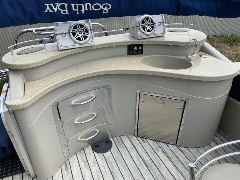 Slide: The Image of 2015 South Bay 724 E boat bar with speakers and sink on deck. - 8
