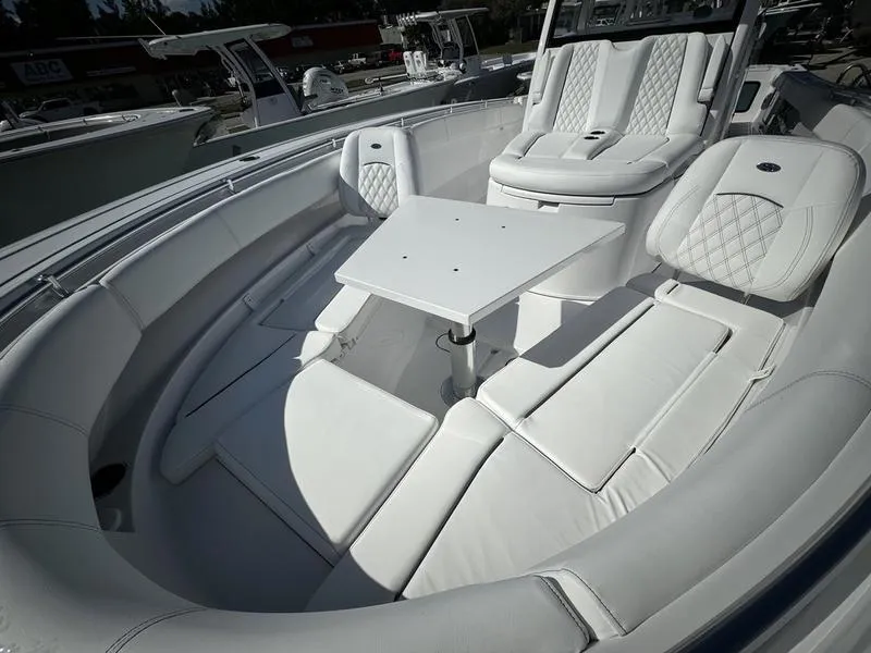 Slide: The Image of 2025 Sportsman Open 352 boat interior with white seating and table. - 13