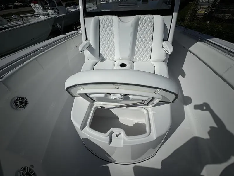 Slide: The Image of 2025 Sportsman Open 352 boat interior with white seating and storage compartment. - 16
