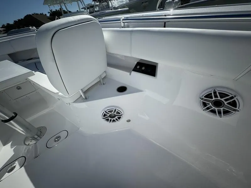 Slide: The Image of 2025 Sportsman Open 352 boat interior with white seating and built-in speakers. - 17