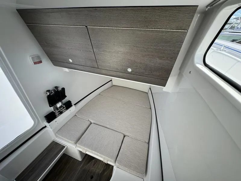 Slide: The Image of 2025 Sportsman Open 352 cabin interior with modern wood finish and compact seating area. - 21