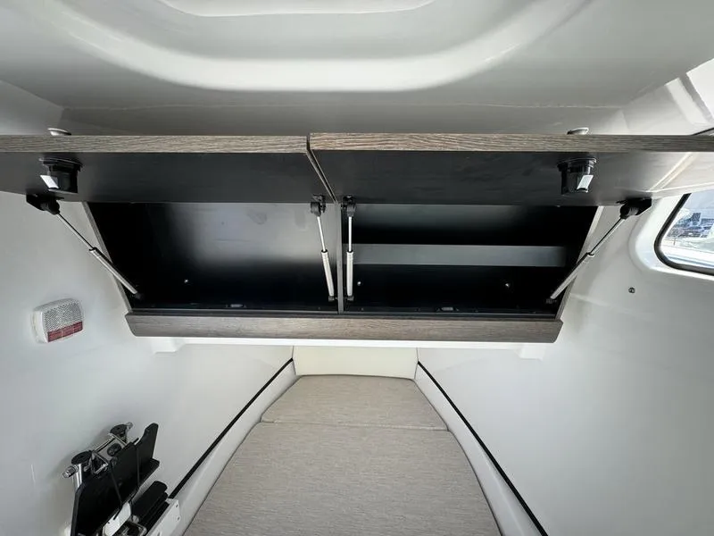 Slide: The Image of 2025 Sportsman Open 352 interior cabin with open storage compartments. - 22