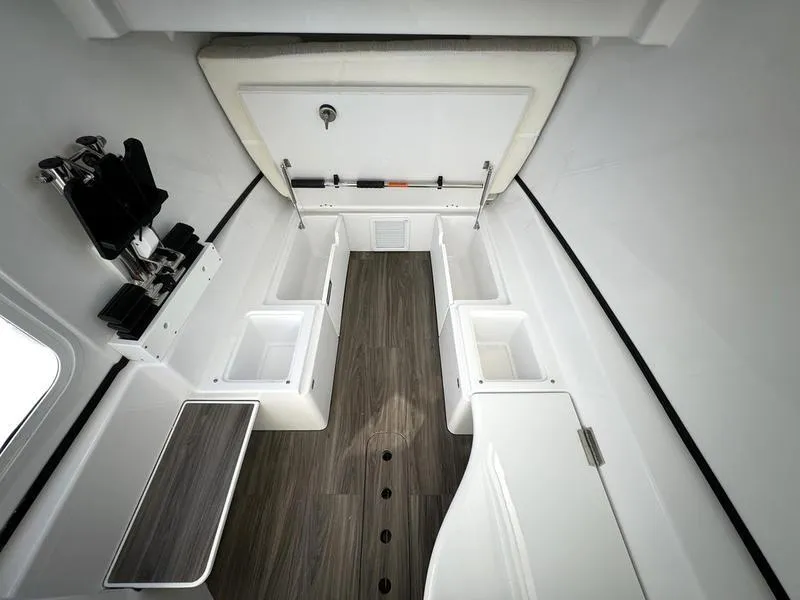 Slide: The Image of 2025 Sportsman Open 352 boat interior with storage compartments and wood flooring. - 24