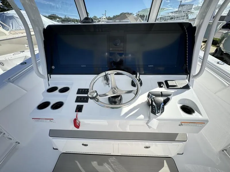 Slide: The Image of 2025 Sportsman Open 352 boat helm with steering wheel and control panel. - 29