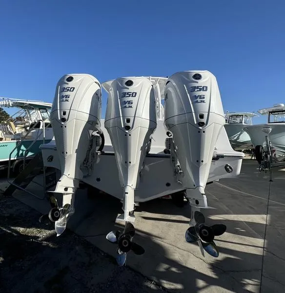 Slide: The Image of 2025 Sportsman Open 352 boat with triple 350 horsepower engines, docked under clear blue sky. - 3