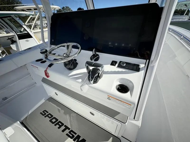 Slide: The Image of 2025 Sportsman Open 352 boat helm with steering wheel and controls. - 30
