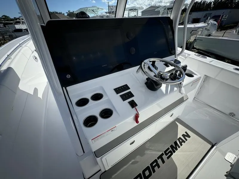 Slide: The Image of 2025 Sportsman Open 352 boat dashboard with steering wheel and controls. - 31