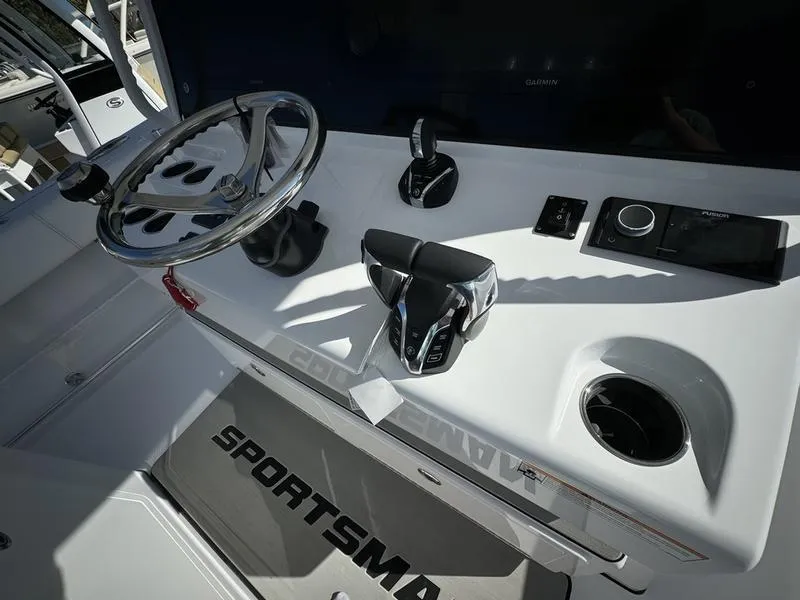 Slide: The Image of 2025 Sportsman Open 352 boat dashboard with steering wheel and controls. - 32