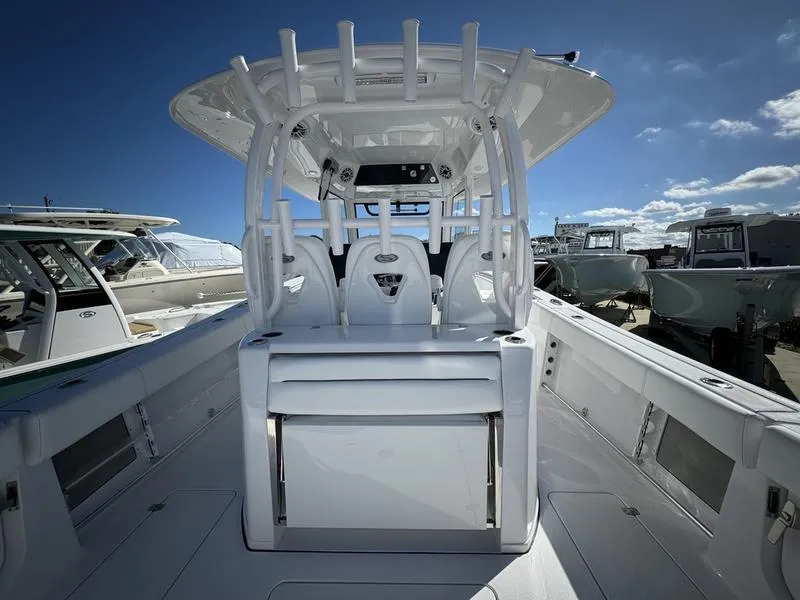 Slide: The Image of 2025 Sportsman Open 352 boat interior with modern helm and seating under clear blue sky. - 44