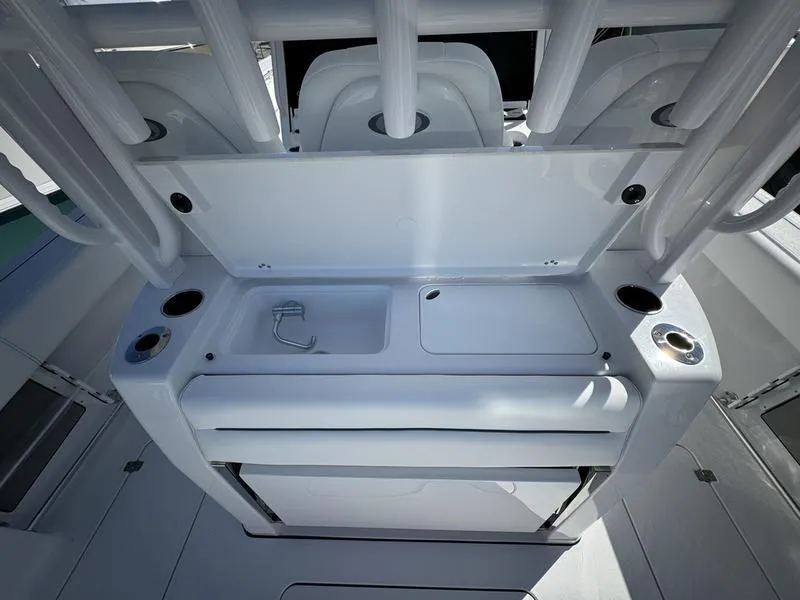 Slide: The Image of 2025 Sportsman Open 352 boat interior with fishing rod holders and storage compartments. - 45