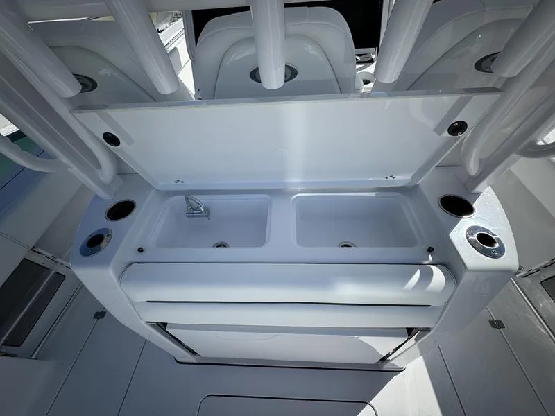 Slide: The Image of 2025 Sportsman Open 352 boat interior with dual sinks and cup holders. - 46