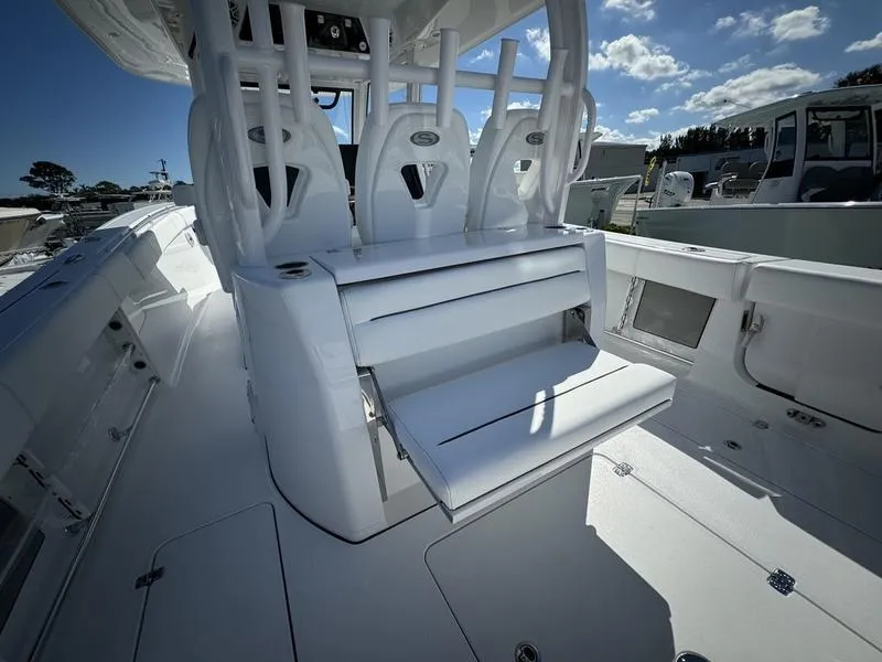 Slide: The Image of 2025 Sportsman Open 352 boat interior with seating and console, under a clear blue sky. - 47