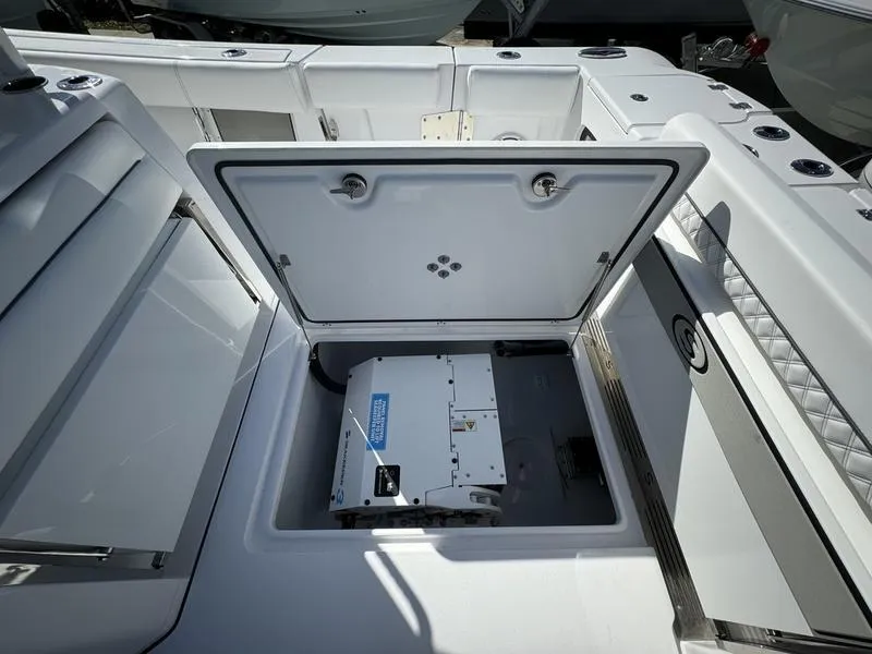 Slide: The Image of 2025 Sportsman Open 352 boat storage compartment with open hatch. - 48