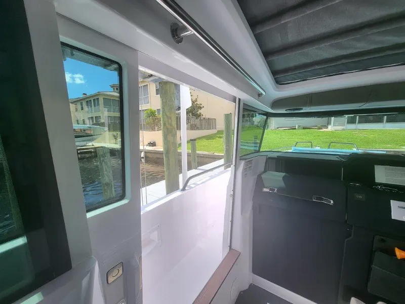 Slide: The Image of Interior view of 2024 Axopar 37 XC CROSS CABIN with large windows and sleek design. - 14