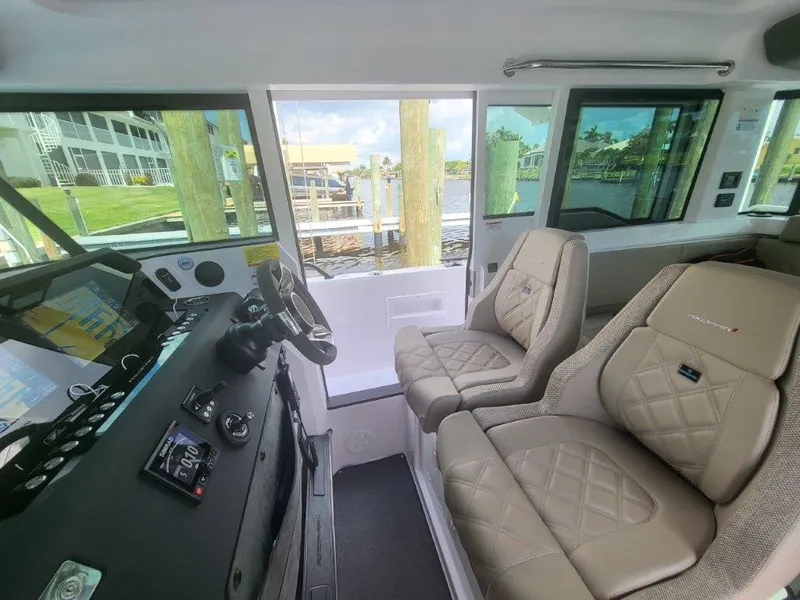 Slide: The Image of Interior of 2024 Axopar 37 XC CROSS CABIN with modern dashboard and comfortable seating. - 17