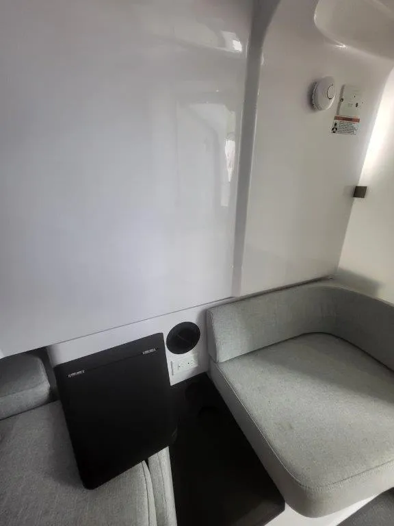 Slide: The Image of 2024 Axopar 37 XC CROSS CABIN interior with modern seating and sleek design. - 30