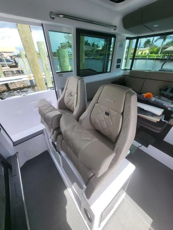 Slide: The Image of 2024 Axopar 37 XC CROSS CABIN interior with luxurious seating and modern design. - 33