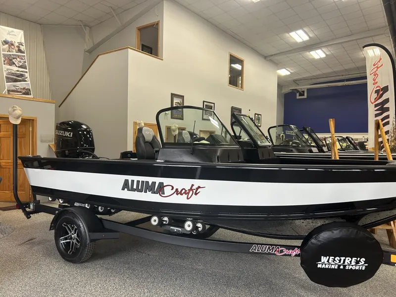 Slide: The Image of 2024 Alumacraft Competitor FSX 185 boat displayed indoors at Westre's Marine & Sports. - 0