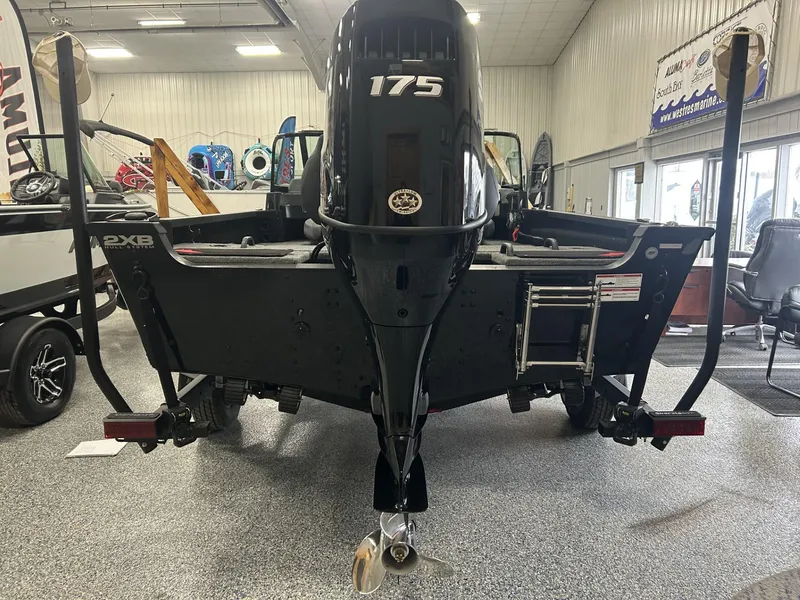 Slide: The Image of 2024 Alumacraft Competitor FSX 185 boat with 175 HP engine in showroom. - 3