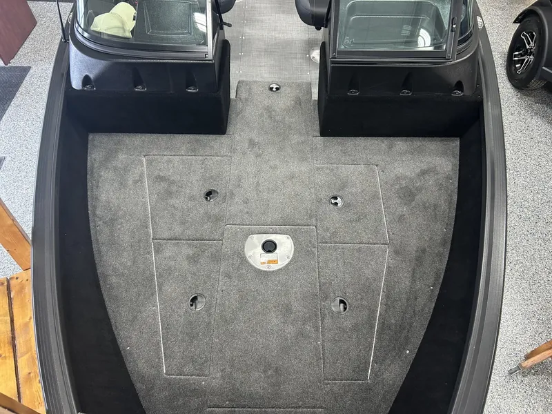 Slide: The Image of 2024 Alumacraft Competitor FSX 185 boat interior with carpeted deck and seating area. - 4