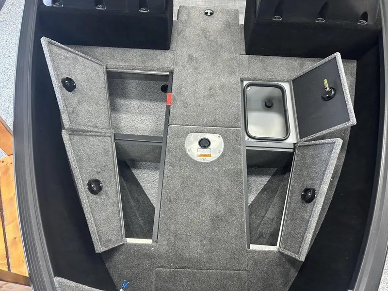 Slide: The Image of 2024 Alumacraft Competitor FSX 185 boat interior with open storage compartments. - 5