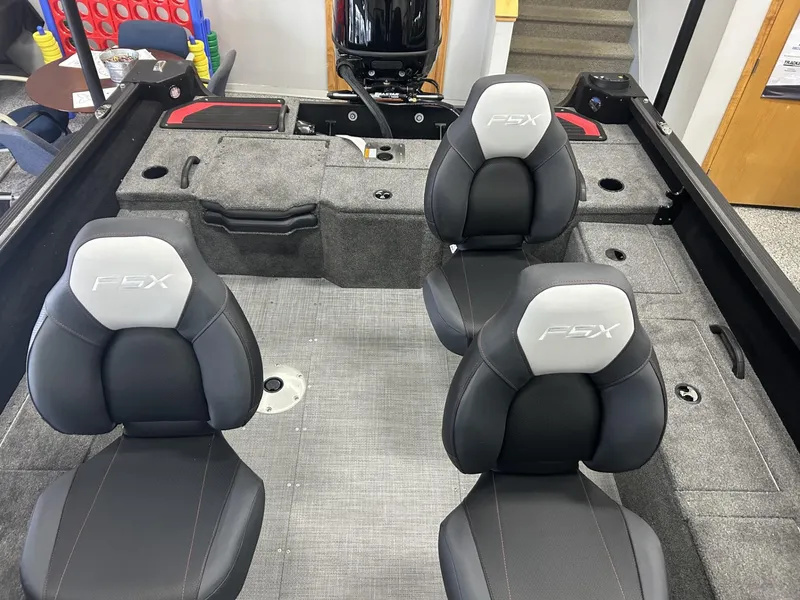 Slide: The Image of 2024 Alumacraft Competitor FSX 185 interior with four seats, gray carpet, and storage compartments. - 8