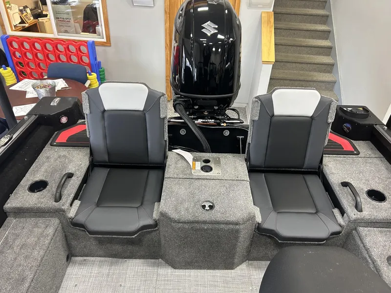 Slide: The Image of 2024 Alumacraft Competitor FSX 185 boat interior with dual seats and motor. - 9