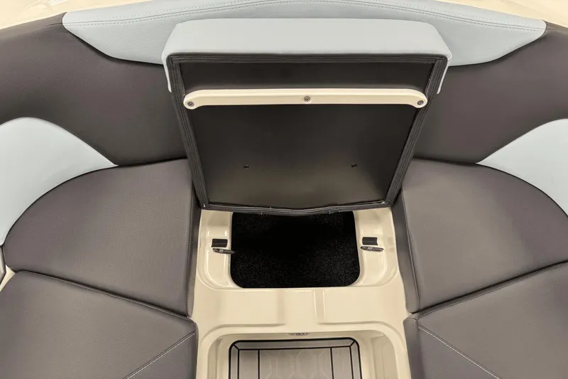Slide: The Image of 2025 MasterCraft XT22 boat interior with open storage compartment, featuring sleek gray and light blue seating. - 13
