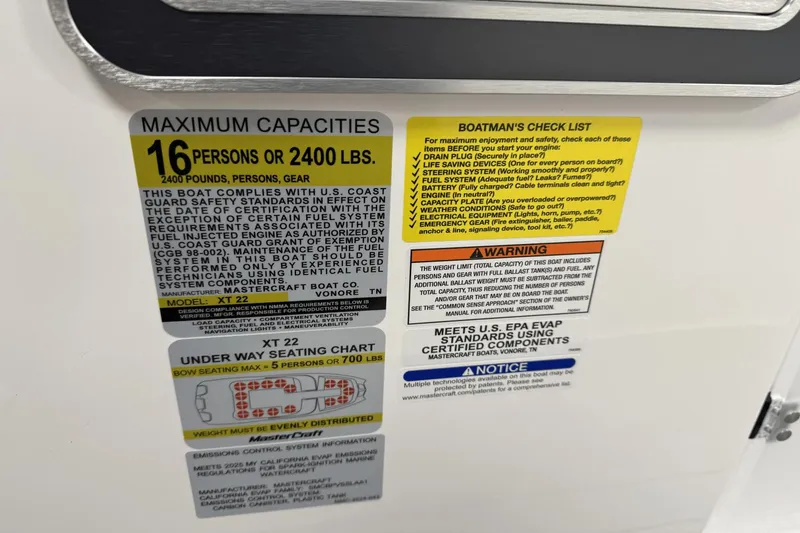 Slide: The Image of 2025 MasterCraft XT22 capacity and safety labels, detailing maximum load and safety checks. - 14