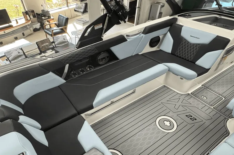 Slide: The Image of 2025 MasterCraft XT22 boat interior with sleek seating and modern design. - 16