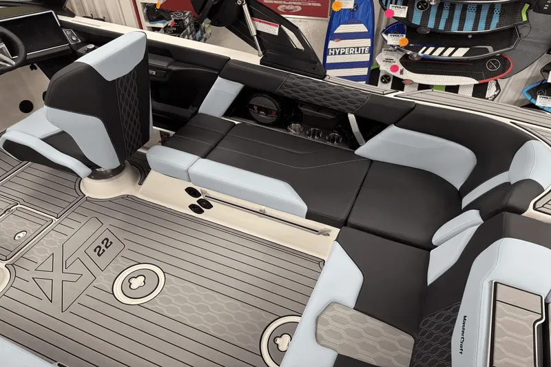 Slide: The Image of 2025 MasterCraft XT22 interior with sleek black and gray seating, modern design elements. - 17