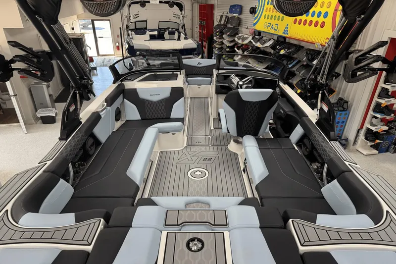 Slide: The Image of 2025 MasterCraft XT22 boat interior with sleek seating and modern design. - 19