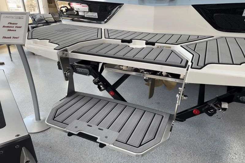 Slide: The Image of 2025 MasterCraft XT22 swim platform with foldable step, displayed indoors. - 23
