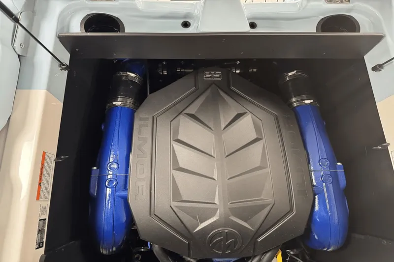 Slide: The Image of 2025 MasterCraft XT22 engine compartment with Ilmor engine, featuring blue components. - 24