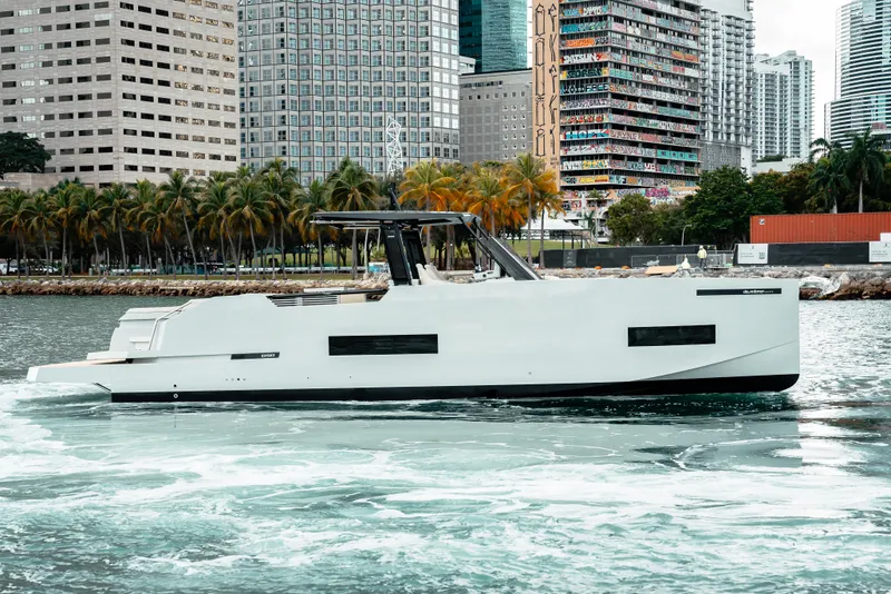 The Image of 2025 De Antonio Yachts D50 OPEN cruising in urban waterfront setting. - 0